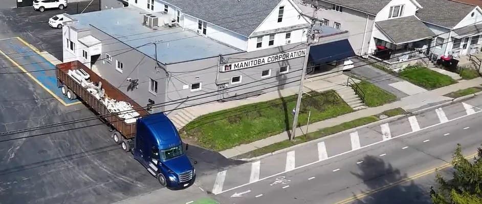 Aerial view of a Manitoba Corporation truck leaving the company yard